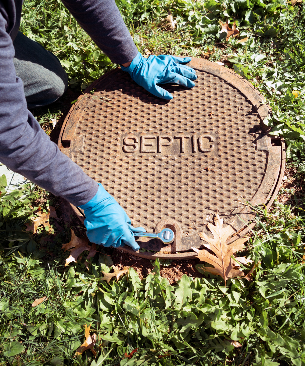 Man opening up a septic tank during septic tank services Barnesville GA.